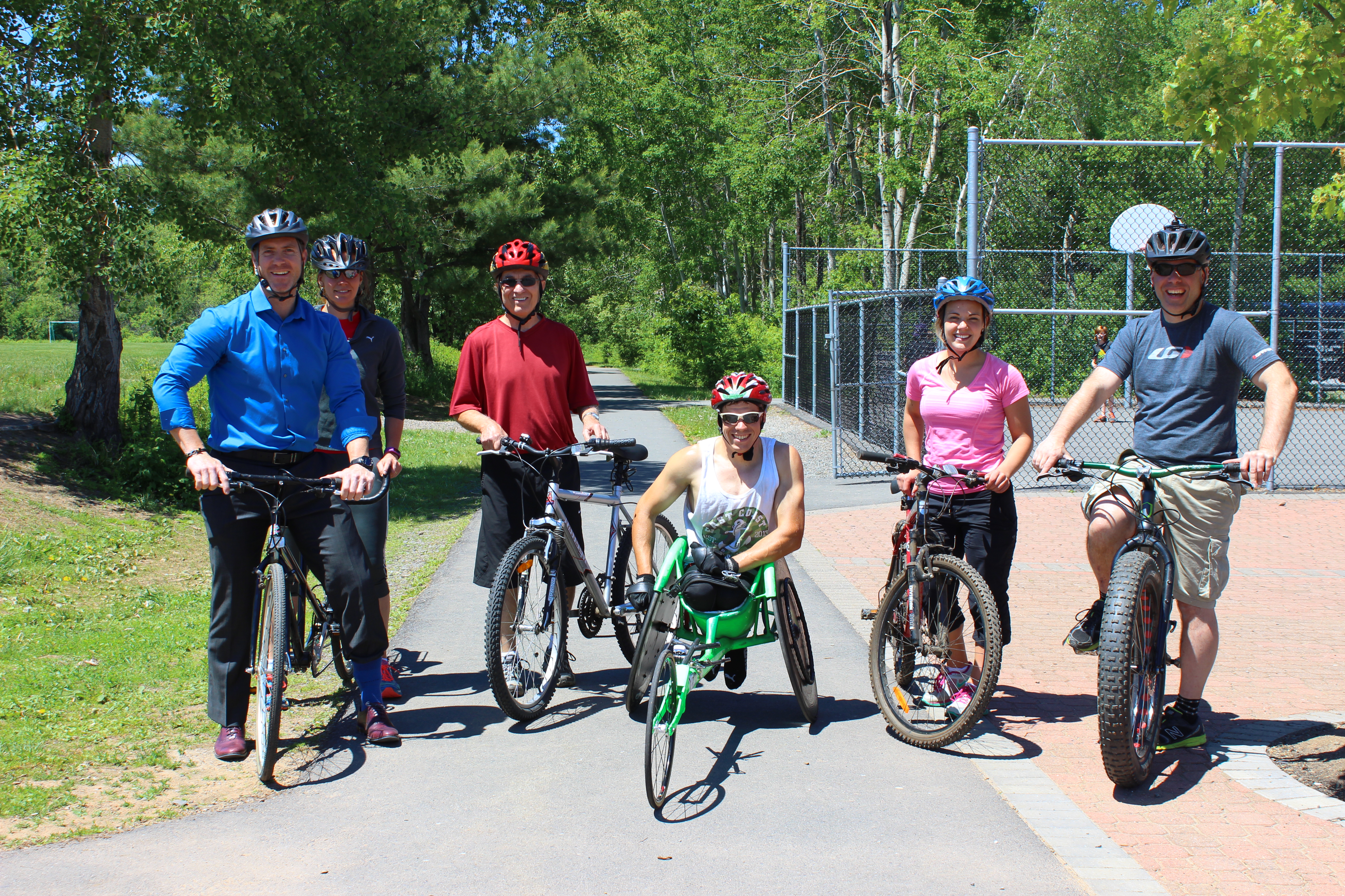Cyclists smiling together on a trail
