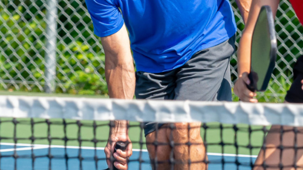 Two people playing pickleball