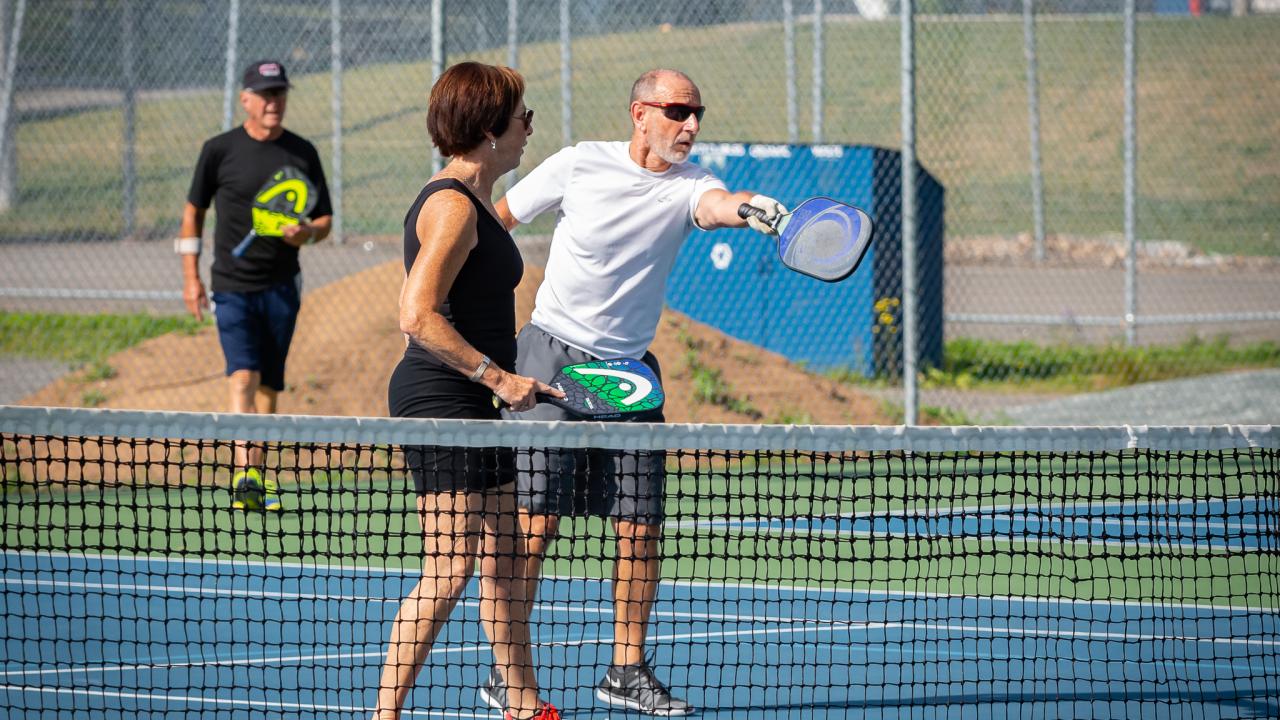 Adults playing pickleball