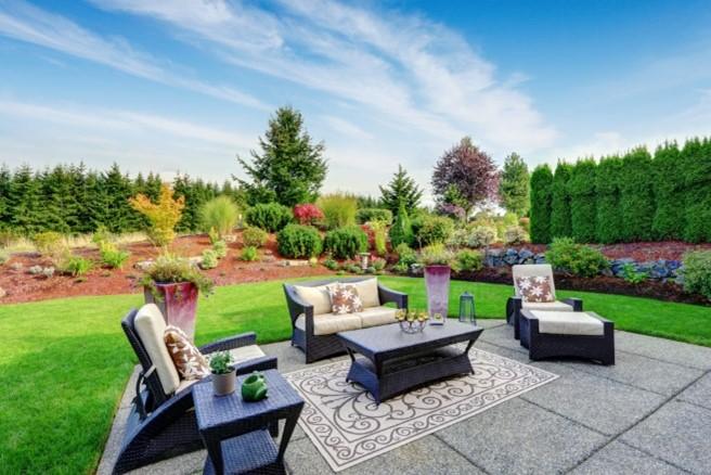 Picture of a landscaped backyard with patio stones and furniture