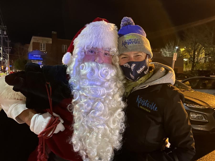 a photo of santa with his arm around mayor snow, who is wearing a mask and smiling with her eyes