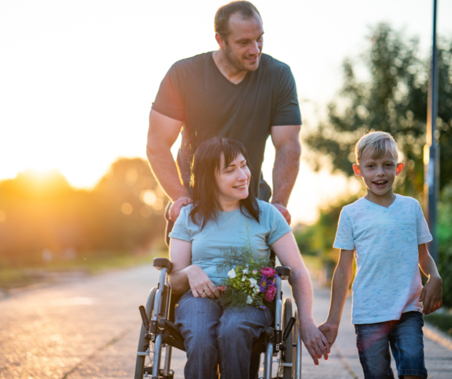 Mother in a wheelchair with husband and son