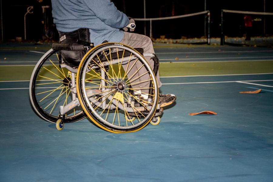 Person in wheelchair playing tennis