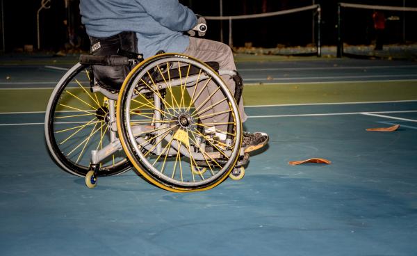 Person in wheelchair playing tennis